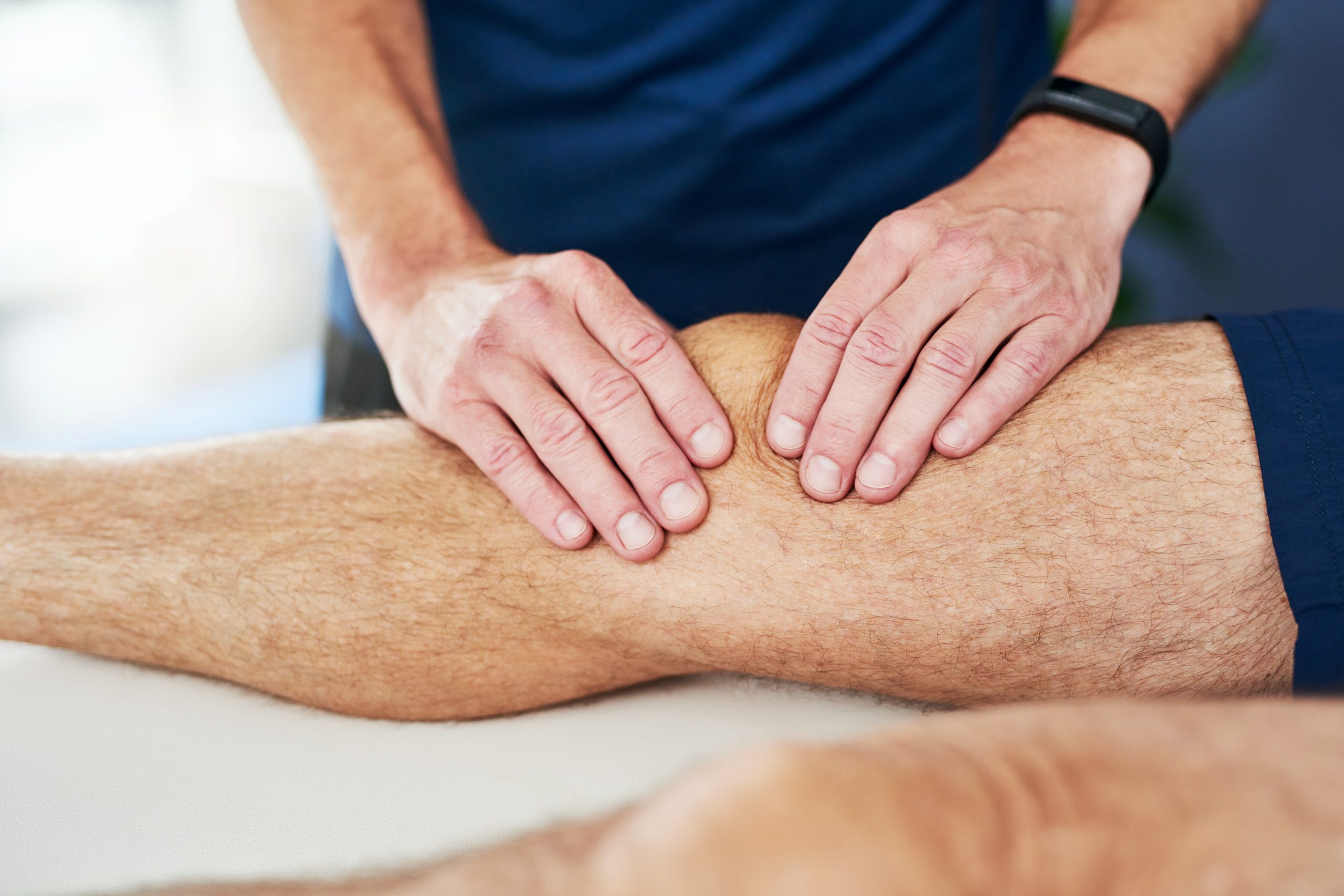 Cropped shot of an unrecognizable male physiotherapist massaging his patient's knee